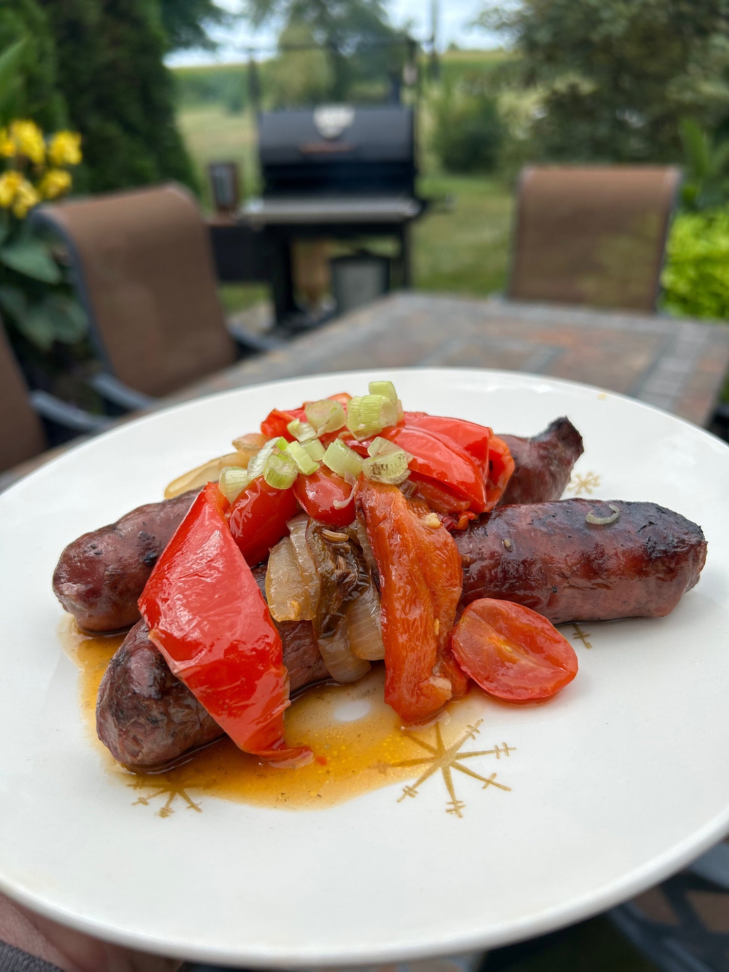 Smoked venison brats with peppers and tomatoes