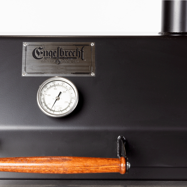 Close up of thermometer nameplate and handle on 1000 Series Original Braten Wood Fired Grill