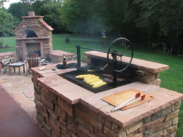Braten Campfire Stainless Steel Grill in customer installed masonry surround with food on grill