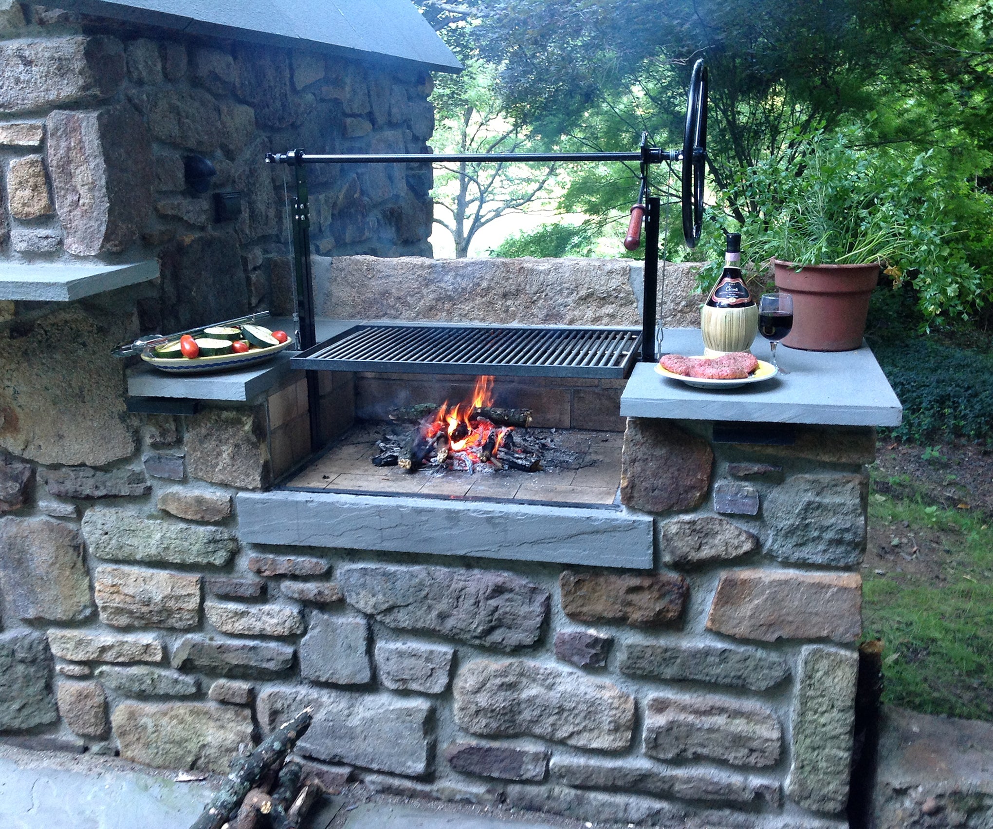 Braten Campfire Stainless Steel Grill in customer installed masonry surround with food