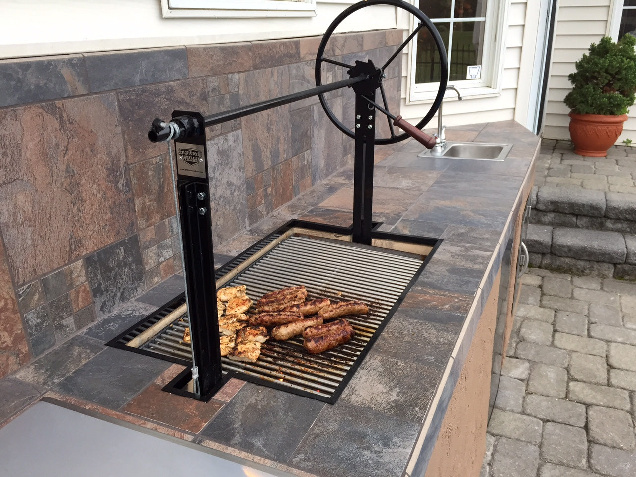 Braten Campfire Stainless Steel Grill in customer installed masonry surround