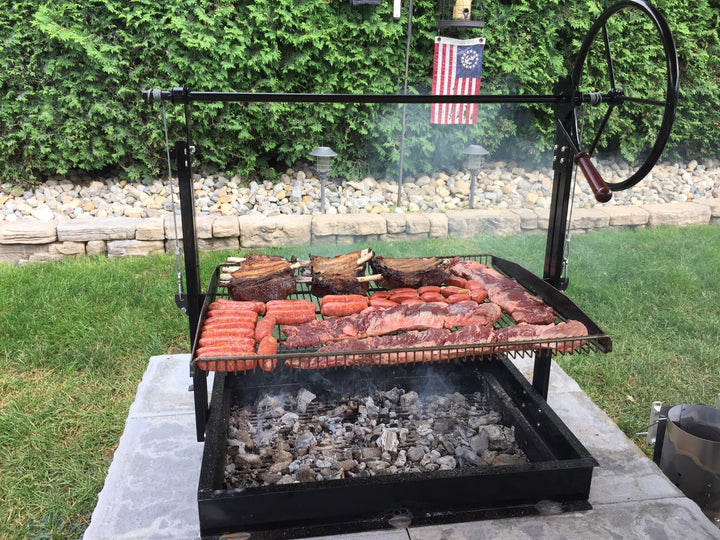 Cooking meat on the Original Braten Campfire Grill in customer backyard